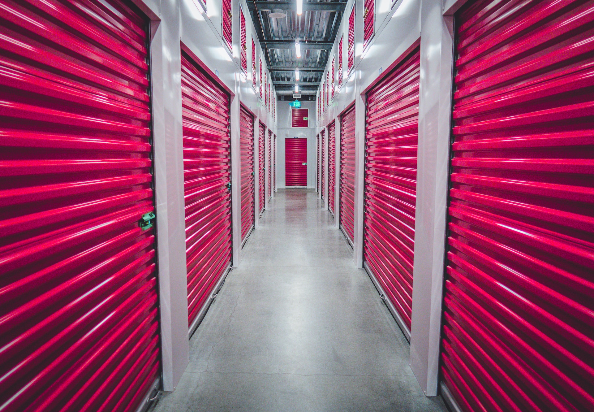 A hallway with red storage units