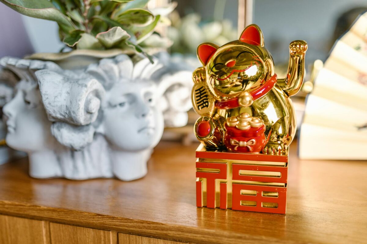 A golden lucky cat on a wooden table